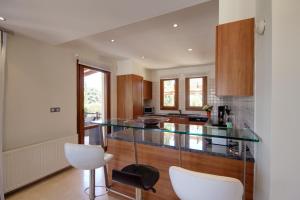 库克里亚Villa UNIDERA的厨房配有玻璃台面和木制橱柜