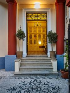 罗德镇Villa Sanyan - Adults Only的大楼的黄色门,有楼梯