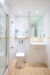 卡诺斯蒂卡诺斯蒂高尔夫“定制酒店“的浴室配有卫生间、盥洗盆和淋浴。