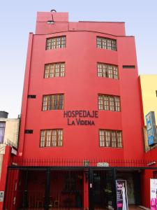 利马维迪纳酒店的红色的建筑,上面写着“Hostelale lavaza”字样