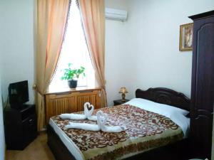 撒马尔罕撒马尔罕拉蒂夫酒店的卧室配有窗户,床上配有2条毛巾