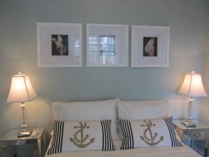 迈阿密海滩Ocean Breeze的卧室配有一张墙上三幅照片的床