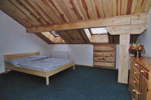 库波瓦霍特克洛泽膳食公寓酒店的一间卧室设有一张床和木制天花板