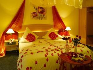Mainhardt晓晨酒店的一间卧室配有一张红色鲜花的大床