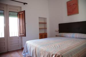塞埃欣Casa del Mesoncico的一间卧室设有床、窗户和门