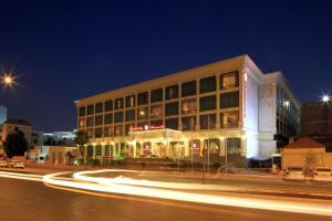 利雅德Ramada by Wyndham Hotel Riyadh的夜幕降临的城市街道上