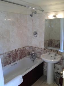 Great Cressingham奥尔德风车酒店的带浴缸和盥洗盆的浴室