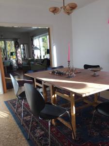 BurträskVilla Insikt Pensionat & Kursgård的一间带木桌和椅子的用餐室