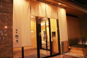 大阪御宿野乃难波天然温泉酒店的窗户前有窗帘的建筑