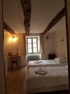 圣莱伊德苏La maison d'Angèle的一间卧室设有两张床和窗户。