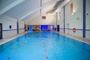 海斯廷斯班纳坦温泉酒店的大楼内一个蓝色的大型游泳池