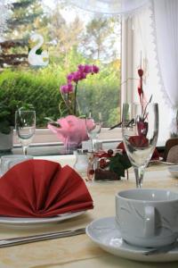 霍瓦赫特艾琳酒店的一张桌子,上面放有酒杯和红餐巾