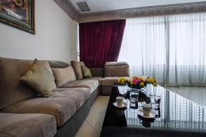 科威特Sara Palace Apartments- family only的客厅配有沙发和桌子