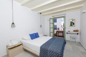 纳克索乔拉纳斯塔西娅公寓式酒店的白色卧室配有床和桌子