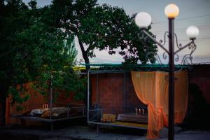 博斯特里Guest House Issyk-Kul Nomad的庭院设有1个带蜡烛和1棵树的天篷