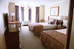 牛谷旅馆及套房酒店客房内的一张或多张床位