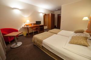 克拉科夫Hotel Major Budget的配有一张床和一张书桌的酒店客房