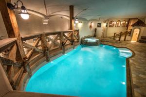 科尔福索西亚萨大酒店的一个带木栅栏和蓝色海水的大型室内游泳池