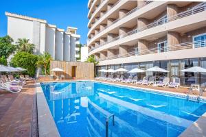 马略卡岛帕尔马Be Live Experience Costa Palma的游泳池,酒店配有椅子和遮阳伞