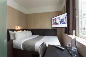 伦敦Z酒店维多利亚的配有一张床和一台平面电视的酒店客房