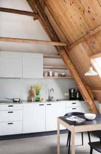 BalkIt Buterhus的厨房配有白色橱柜和桌子