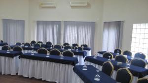 普拉伊拉多比莱尼Massala Beach Resort, Lda的配有蓝色桌椅和窗户的客房