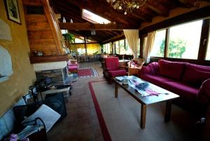 宏达瑞比亚易克特克斯乡村民宿的客厅配有紫色沙发和桌子