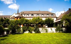 特里尔Boutiquehotel Kloster Pfalzel的前面有绿色草坪的大房子