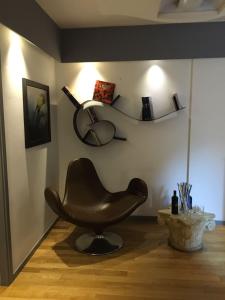 博洛尼亚Indipendenza Boutique的坐在墙上的棕色椅子