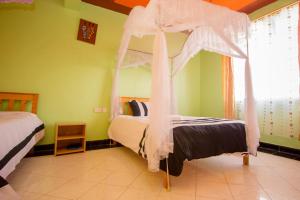 内罗毕Airport Gate View Hotel的一间卧室配有一张带天蓬的床