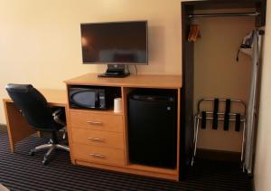 瓦列霍丽晶酒店的一张桌子、一台电视和一台电脑