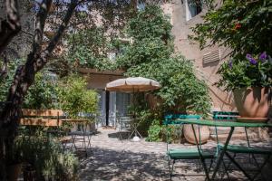卢马罕加德斯老式住宿加早餐旅馆的一个带桌椅和遮阳伞的庭院