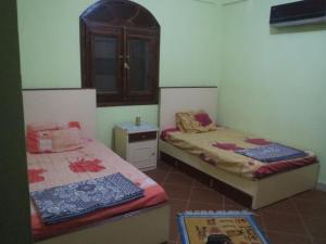 达哈布博达迪达哈布别墅的一间设有两张床和一张桌子的房间