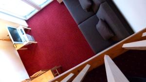 比维奥菲林格力处纳公寓的一间设有红色墙壁的客房和带电视的楼梯
