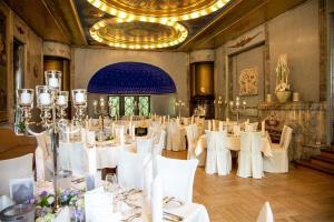 达姆施塔特霍夫古特迪普斯霍夫酒店及KG餐厅的用餐室配有白色的桌子和白色的椅子
