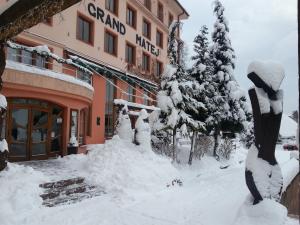 班斯卡 - 什佳夫尼察马捷豪华大酒店 的前面有一堆积雪的建筑物