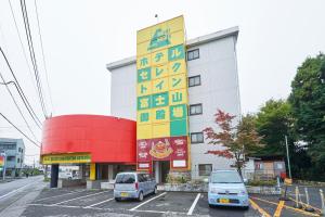 御殿场市富士山御殿场精选酒店(Select Inn Fujisan Gotemba)的停车场内有车辆的建筑物