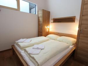 纽科琴格罗斯夫Apartment Wildkogel Appartement 1的一间卧室配有一张床,上面有两条毛巾