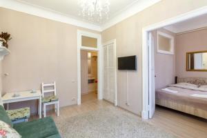 莫斯科旧阿尔巴特奇迹公寓的一间卧室设有一张床和一间客厅。