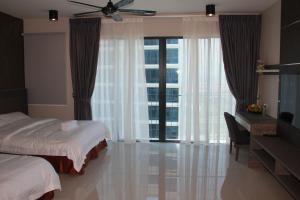 实达阿南实达酒店套房服务公寓的一间卧室配有一张床、一张书桌和一个窗户。