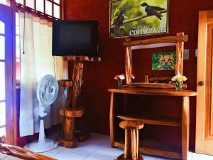 普约Hosteria Don Elias的客房设有电视和带风扇的桌子。