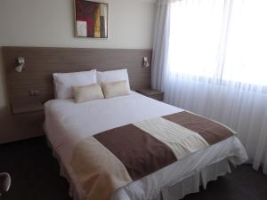 Tempora Apart Hotel客房内的一张或多张床位