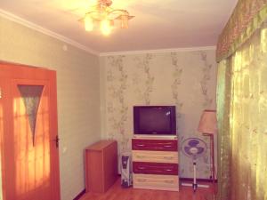 Krasnoye PoleАхметова 10的客厅配有梳妆台上的电视