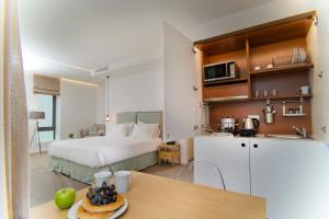 雅典NLH FIX | 街区生活方式酒店的一间带一张床的房间和一间带桌子的厨房
