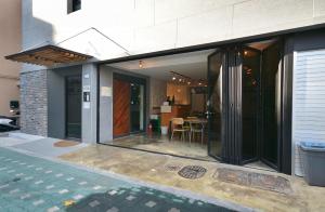 首尔Sunnyhill Hostel Hongdae的玻璃门和用餐区的房子