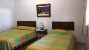 Hotel Los Mezquites客房内的一张或多张床位