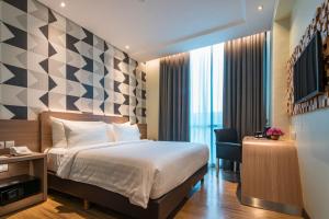 Luminor Hotel Pecenongan Jakarta By WH客房内的一张或多张床位