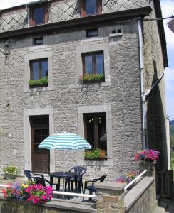 Comblain-au-PontGite Du bac的大楼前的桌椅和遮阳伞