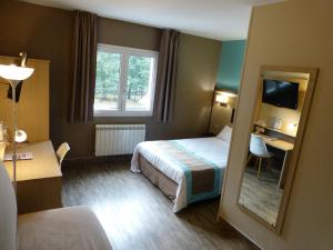 Hotel ARBOR - Les Hunaudieres - Le Mans Sud - Mulsanne客房内的一张或多张床位