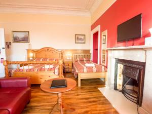 爱丁堡科斯托芬妮旅馆酒店的客厅设有两张床和壁炉